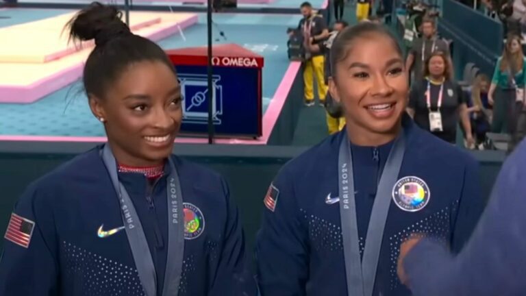 Simone Biles and Jordan Chiles are interviewed after receiving gold and bronze medals, respectively, for the individual floor exercise at the 2024 Paris Olympics.