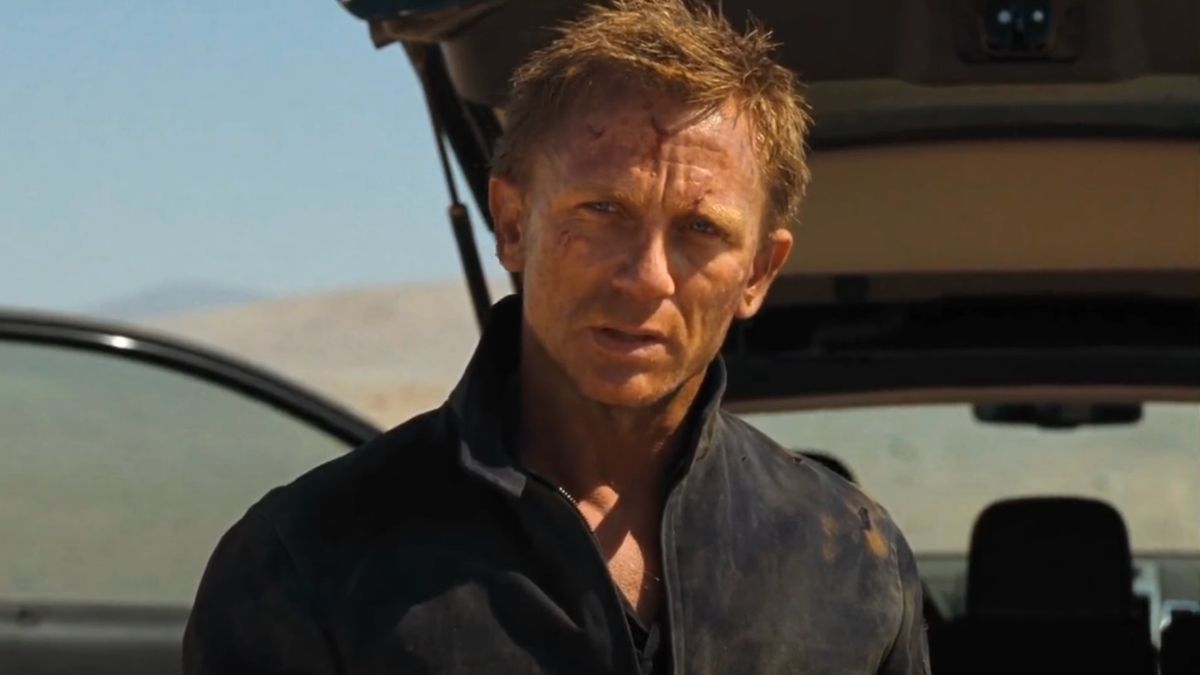 Daniel Craig stands with a determined expression, in front of his car trunk, in Quantum of Solace.