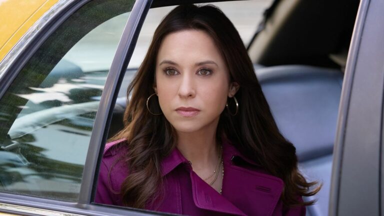 Lacey Chabert looks out from a taxi in Hallmark's His and Hers.