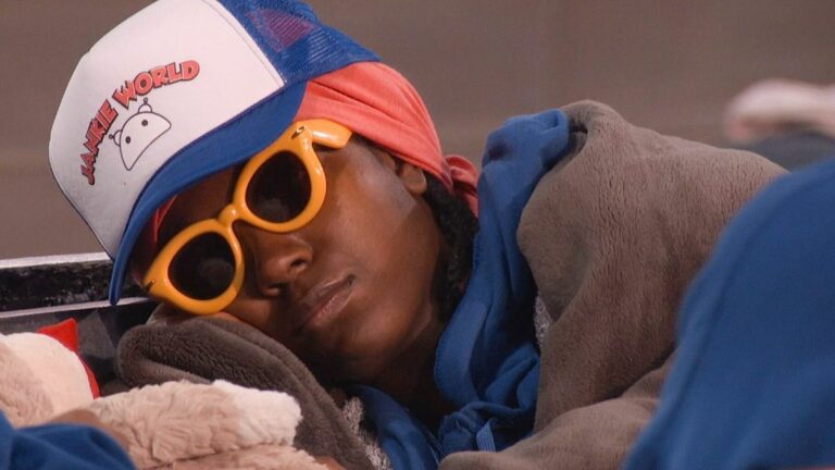 T'Kor sleeping with sunglasses in the Big Brother house. 