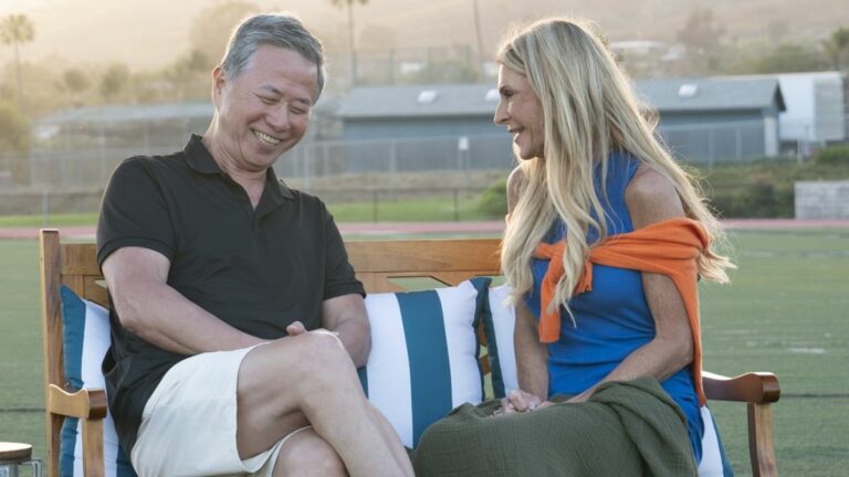 Joan Vassos and Charles Ling sit on a bench to talk after their kickball date on The Golden Bachelorette Season 1.